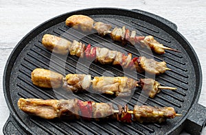 Meat on wooden skewers coocked on grill. photo