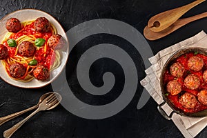 Meatballs banner design. Meatbalss with pasta, with tomato sauce and herbs, overhead flat lay shot on a dark background
