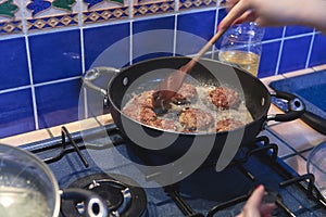 Meatballs cooking in pot