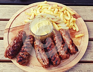 Meatballs meat french fries mutard plate sausages romanian mici