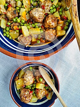 Meatballs with peas and potatoes photo