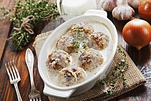 Meatballs with rice in a creamy sauce