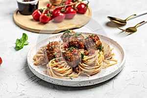 Meatballs served over italian spaghetti pasta with tomato sauce on a light background. Italian food. banner, menu, recipe place