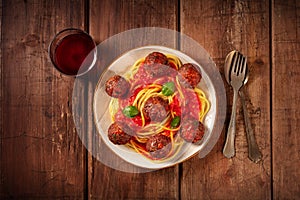Meatballs with spaghetti and wine, overhead flat lay shot photo