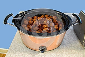 Meatballs in Stainless Crock Pot Slow Cooker on Counter