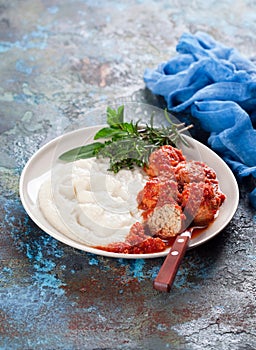 Meatballs in tomato sauce with mashed potato