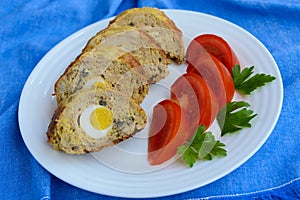 Meatloaf with mushrooms and boiled egg.