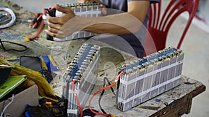 Mechanic assembling the electric car battery. EV