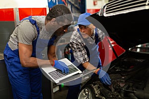 Mechanic and assistant working at service