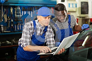 Mechanic and assistant working at service