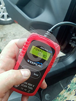 Mechanic with auto diagnostics in his hands