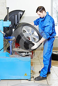 Mechanic at auto wheel tyre changer