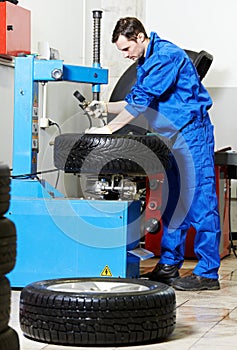 Mechanic at auto wheel tyre changer