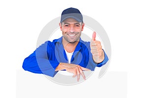 Mechanic with blank placard gesturing thumbs up