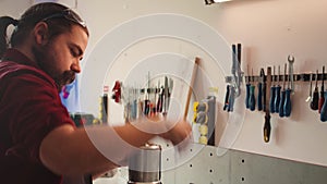 Mechanic in carpentry shop changing rotor part on spindle moulder