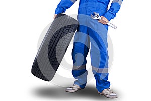 Mechanic carrying a tire and wrench