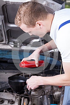 Mechanic changing car oil