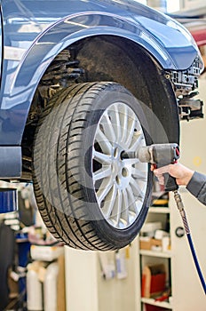 Mechanic changing car wheel.