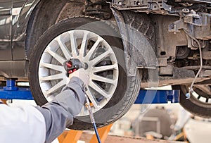 Mechanic changing car wheel.