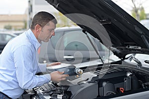 Mechanic changing motor oil to engine