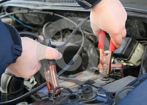 Mechanic charges the battery car photo