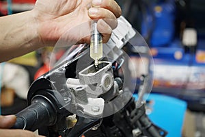 Mechanic Check and use syringe to transfer and Add Brake Fluid,in garage, motorcycle maintenance and service and repair concept