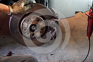 Mechanic checking car brake system and driveshaft in vintage garage,car garage service concept