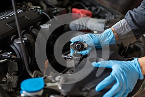 Mechanic checking car radiator, Close-up