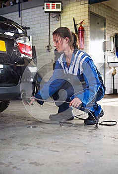 Mechanic checking diesel exhaust emission rates