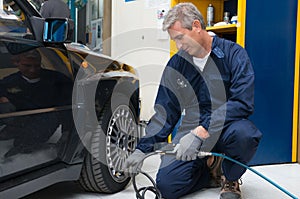 Mechanic Checking Tyre Pressure