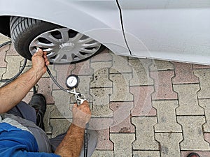 Mechanic checks tire pressure