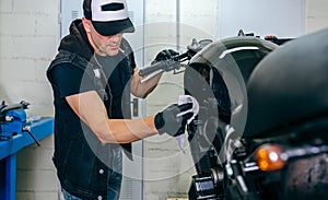 Mechanic cleaning a motorcycle