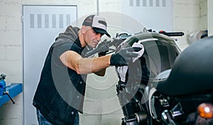 Mechanic cleaning a motorcycle