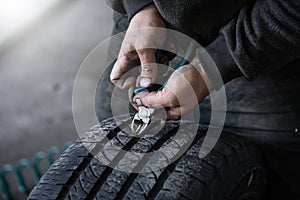 mechanic closes a hole in a tire in a workshop