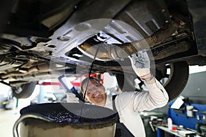 Mechanic conducts thorough inspection car garage.