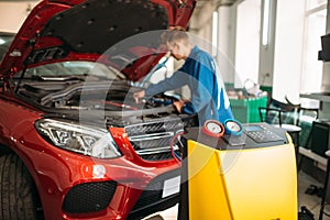 Mechanic connects air conditioning system