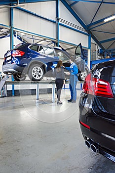 Mechanic and customer in garage