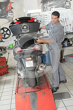 mechanic customizing scooter