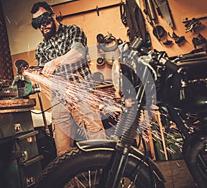 Mechanic doing lathe work in motorcycle customs garage