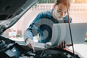 Mechanic Engineer is Diagnosing Car Engine and Electric Adjusting Transmission With Computer Laptop, Automobile Service Man