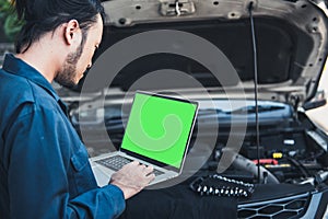 Mechanic Engineer is Diagnosing Car Engine and Electric Adjusting Transmission With Computer Laptop, Automobile Service Man