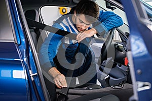Mechanic Examining Car Seat Belt