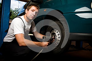 Mechanic fixing auto in car service photo