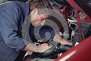 Mechanic fixing auto in car service photo