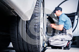 Mechanic fixing a car Under Maintenance in a Certified Auto Service