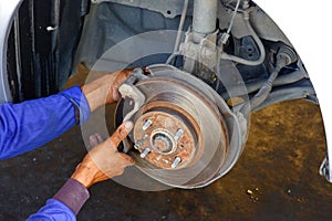 The mechanic is fixing the problem car.