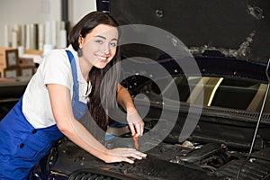 Mechanic in garage or workshop repairing car