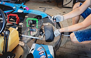 The mechanic go kart racing service change the wheels