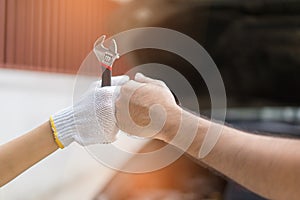 Mechanic hand checking and fixing a broken car in garage.hand o