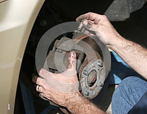 Mechanic Hands On Brakes